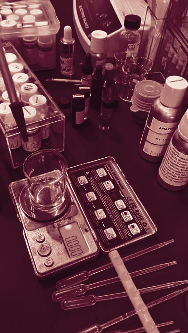 Vivian’s blending bench: a beaker on a scale, pipettes and rows of accord bottles