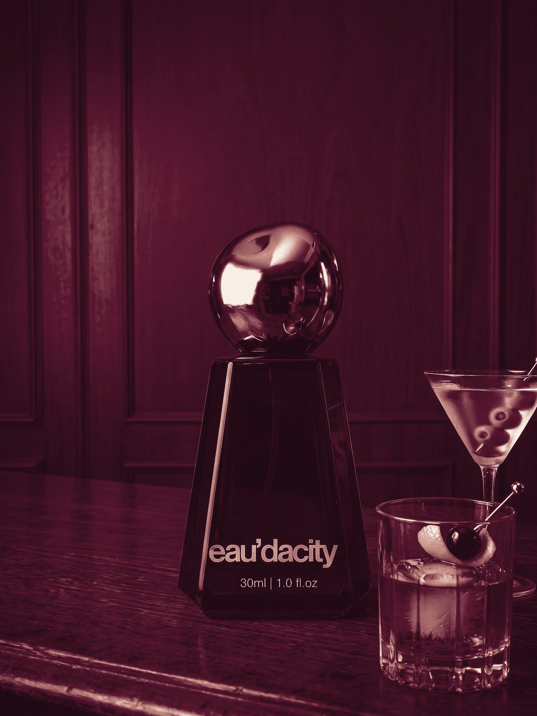 The eau’dacity Icon bottle on a bar beside a martini and an old fashioned