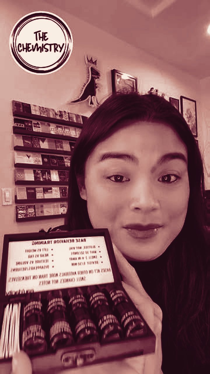 Vivian holding open a wooden box of perfume base vials